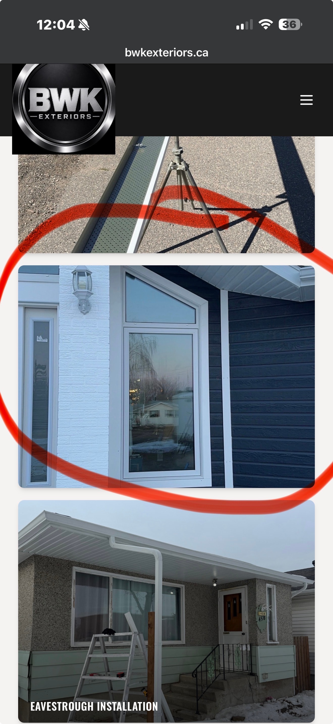 Blue vinyl siding with white trim and large window — BWK Exteriors Regina